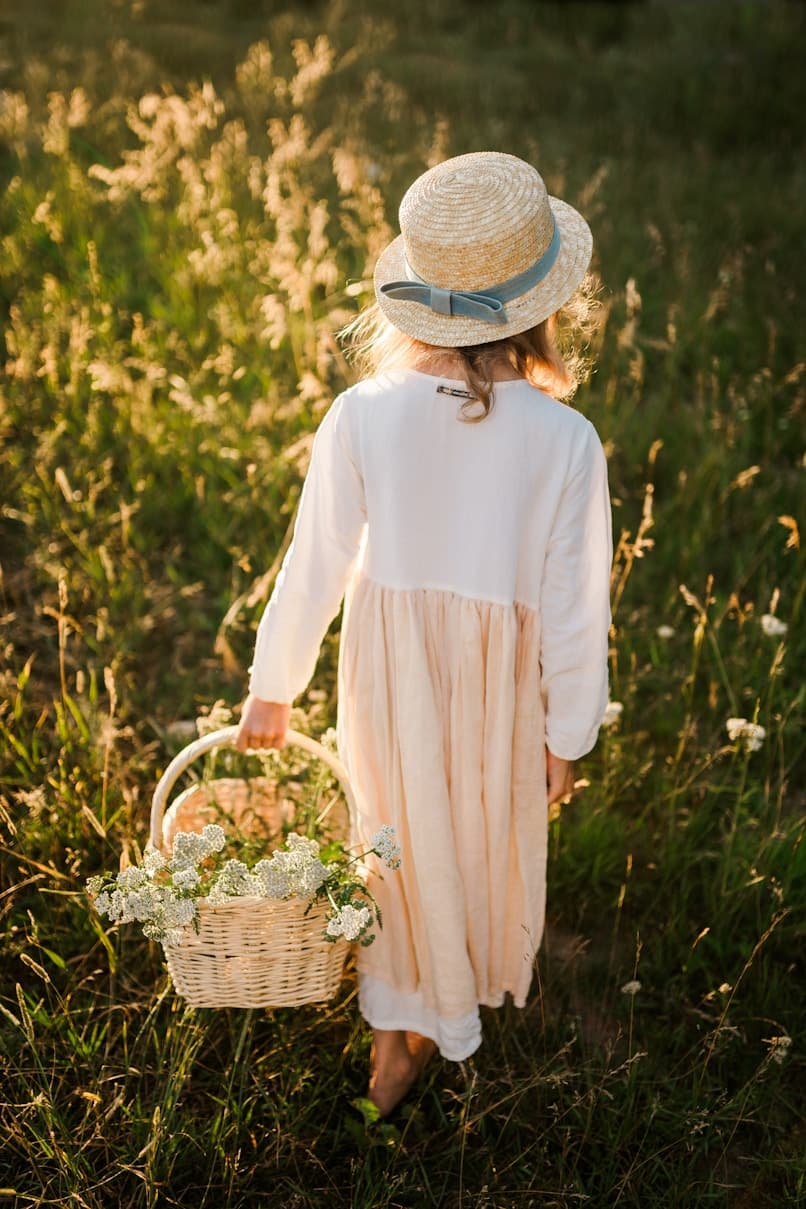 Girl with floral basket in field